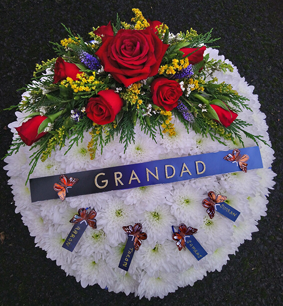 Oadby Funeral Flowers, Wigston Funeral Flowers, Market Harborough Funeral Flowers, Posy Tribute, Traditional stlye with red spray & GRANDAD lettering on blue ribbon