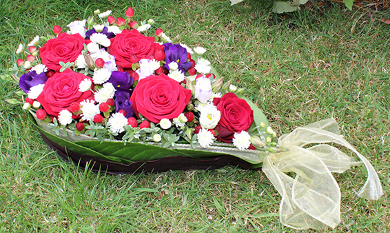 Oadby funeral flowers, Wigston funeral flowers, Market Harborough Funeral Flowers, Leicester Funeral Flowers, Bespoke Teardrop flower tribute, red roses, blue, white and ribbons