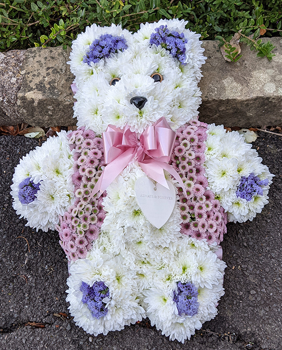 Oadby funeral flowers, Wigston funeral flowers, Market Harborough Funeral Flowers, Small standing Teddy bear tribute, white & purple flowers