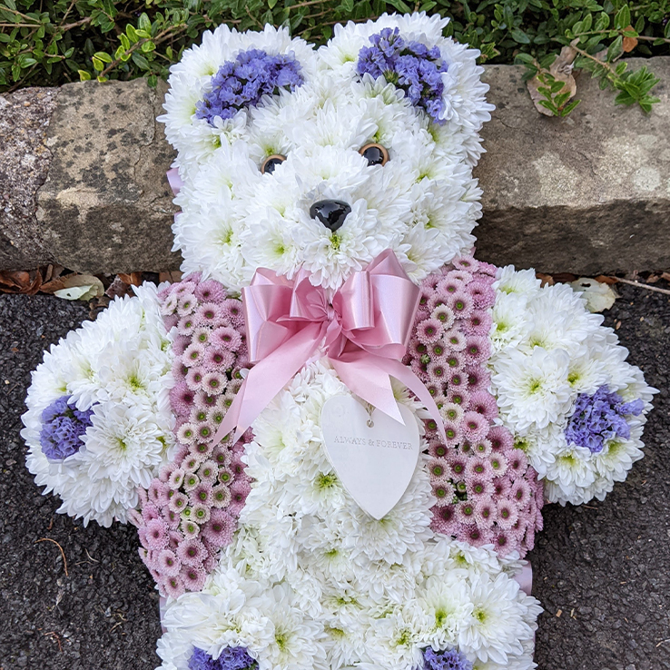 Market Harborough Funeral Flowers, Large 3D Floral Teddy bear tribute with lilac jacket made of flowers.