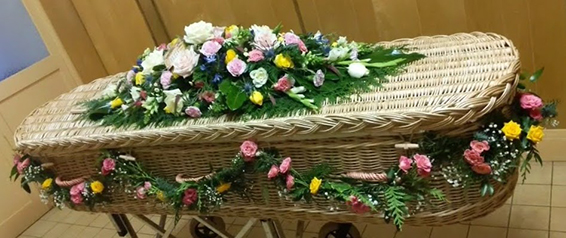 Oadby Funeral Flowers, Wigston Funeral flowers, Market Harborough Funeral Flowers, Leicester funeral flowers, Beautiful swagged garland for casket, with greenery, lemon & pink spray roses & gypsophilla
