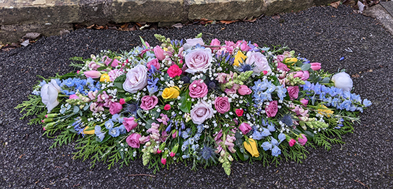 Oadby Funeral Flowers, Wigston Funeral Flowers, Leicester funeral flowers, Very pretty Pink, lilac & blue delphinium casket spray