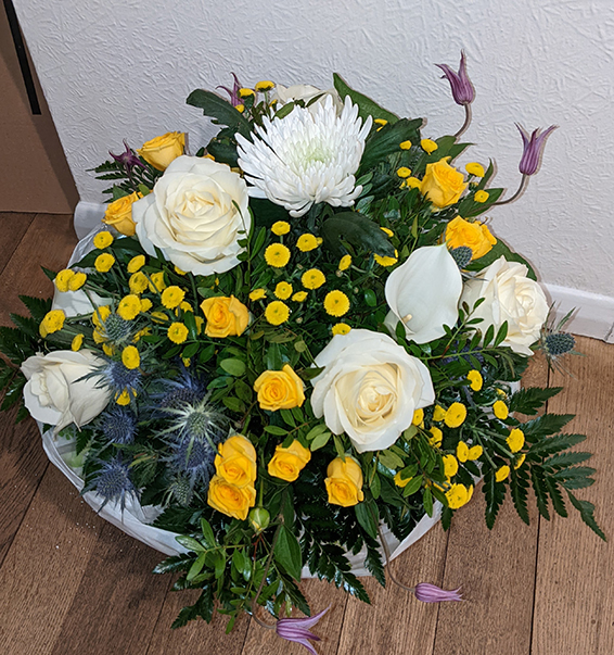Oadby Funeral Flowers, Wigston Funeral Flowers, Market Harborough Funeral Flowers, Condolence Flower Bouquet, with white roses, yellow spray roses, blue eryngium, purple clematis.