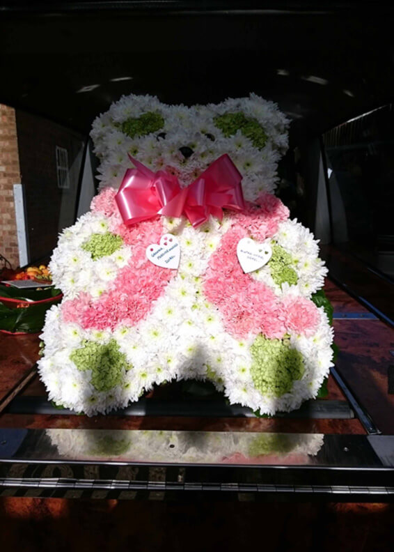 Oadby florist, Wigston florist, Leicester funeral flowers, Large pink teddy bear tribute on a casket