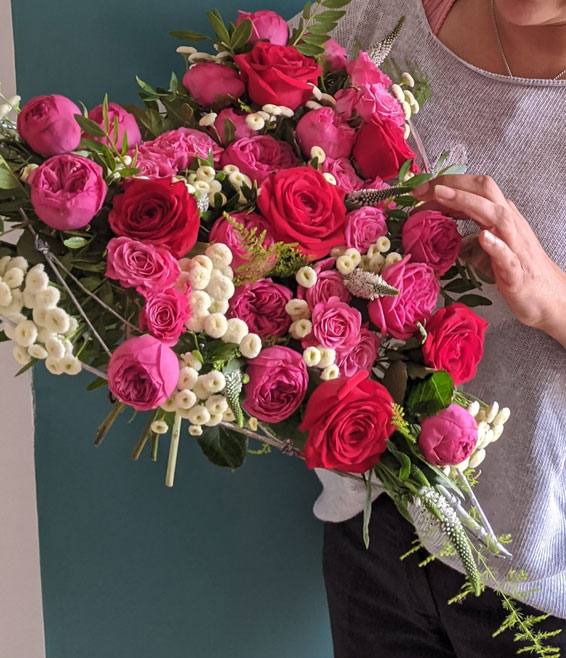 Oadby florist, Wigston florist, Heart shaped bouquet with red an pink roses, held in hands
