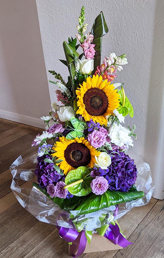 Oadby florist, Wigston florist, Purple hydrangea, sunflower, lilac and white rose, vertical handtied bouquet