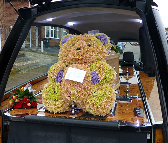 Oadby funeral flowers, Wigston funeral flowers, Market Harborough Funeral Flowers, Large 3D Teddy bear tribute,peach flowers.