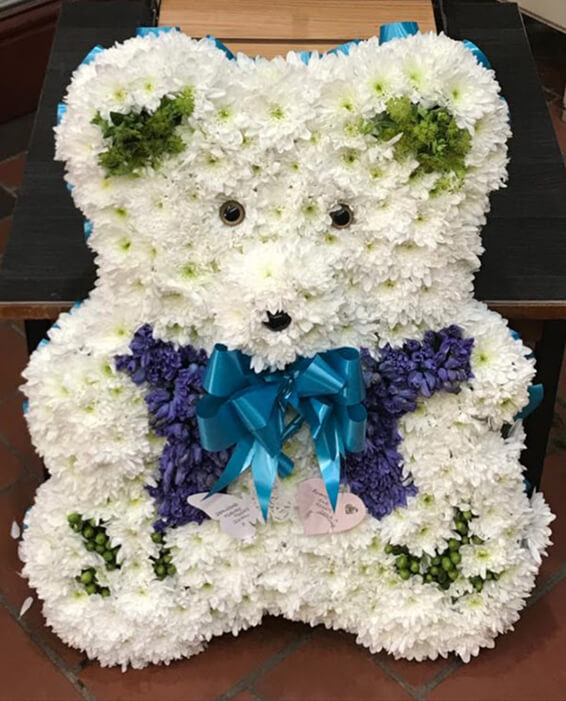 Oadby funeral flowers, Wigston funeral flowers, Market Harborough Funeral Flowers, Large Teddy bear tribute, white & blue flowers