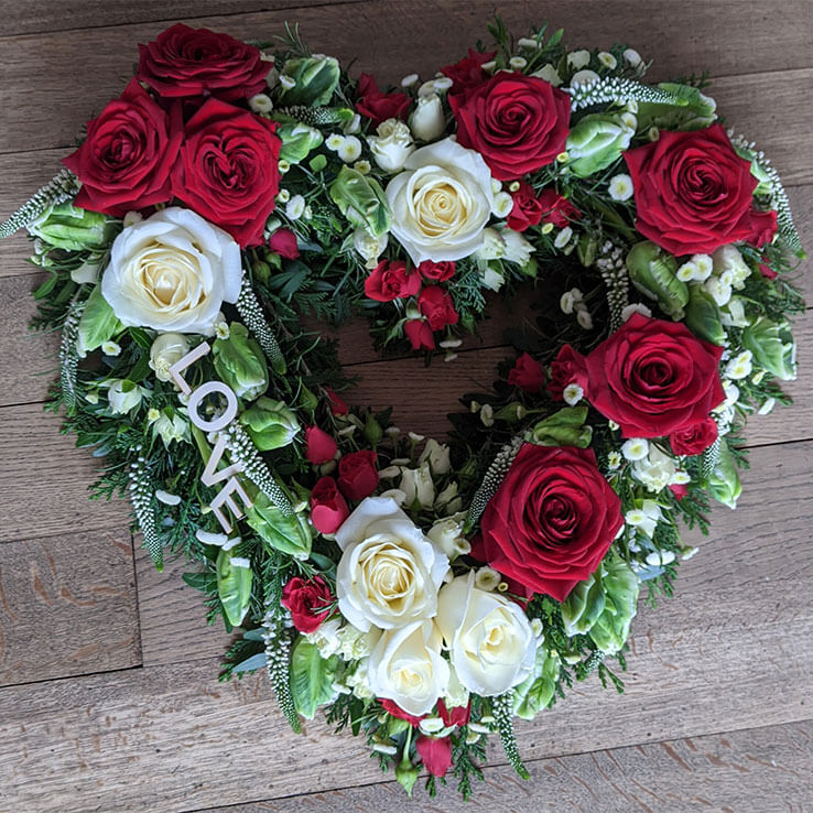 Market Harborough Funeral Flowers, Large, luxury, red heart tribute with LOVE lettering.