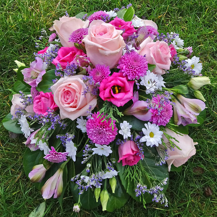 Market Harborough Funeral Flowers, Round posy arrangement with pink and lilac flowers.