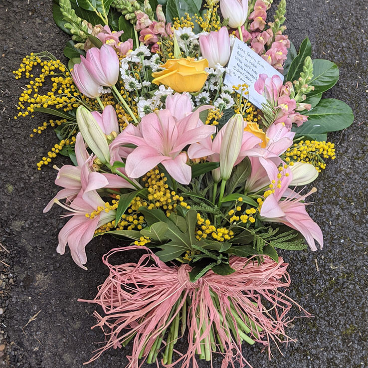 Market Harborough Funeral Flowers, Handtied flat sheaf, with raffia bow.