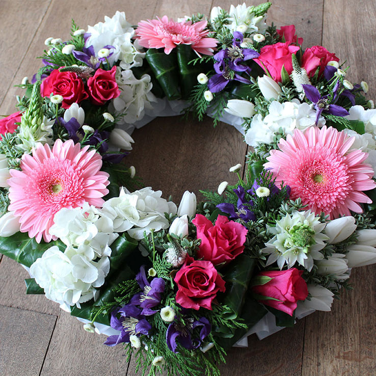 Market Harborough Funeral Flowers, Wreath ring with pink, white and purple flowers.