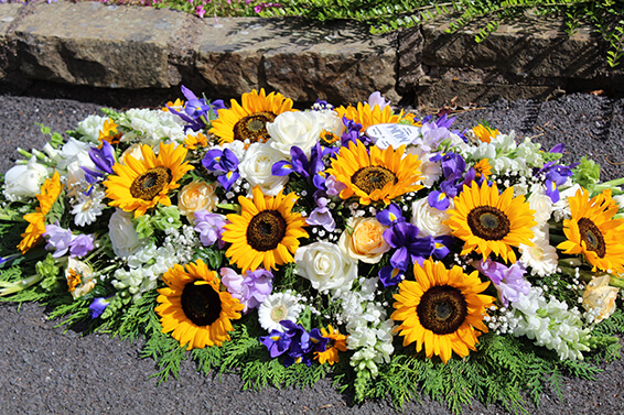 Oadby Funeral Flowers, Wigston Funeral flowers, Leicester funeral flowers, Sunflower and iris Casket spray