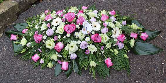 Oadby Funeral Flowers, Wigston Funeral flowers, Leicester funeral flowers, Pink white and lilac flowers Casket spray