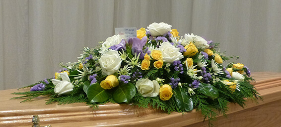 Oadby Funeral Flowers, Wigston Funeral flowers, Leicester funeral flowers, White yellow and lilac Casket spray