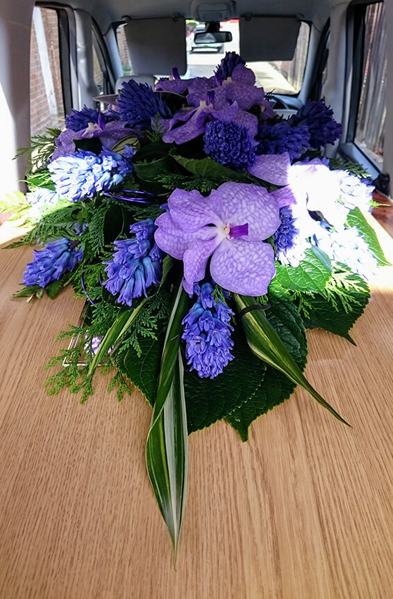 Oadby Funeral Flowers, Wigston Funeral flowers, Leicester funeral flowers, Purple orchid and hyacinth, scented Casket spray