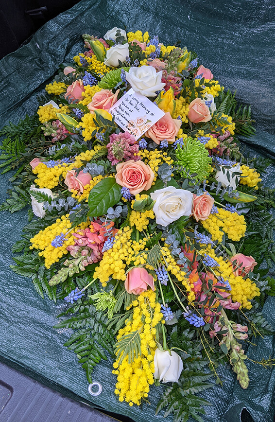 Oadby Funeral Flowers, Wigston Funeral flowers, Leicester funeral flowers, Peach rose and yellow mimosa Casket spray