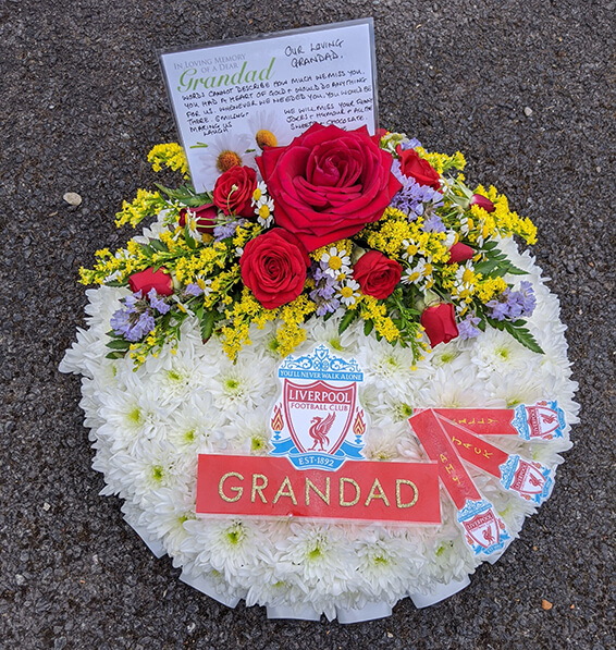 Oadby Funeral Flowers, Wigston Funeral Flowers, Market Harborough Funeral Flowers, Posy Tribute,Traditional stlye with red spray & GRANDAD lettering on red ribbon & Liverpool Football club badge