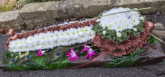Oadby funeral flowers, Wigston funeral flowers, Market Harborough Funeral Flowers, Leicester Funeral Flowers, Bespoke funeral Punjabi 3D tumbi tribute, Musical instrument tribute made in flowers, with peacock feathers
