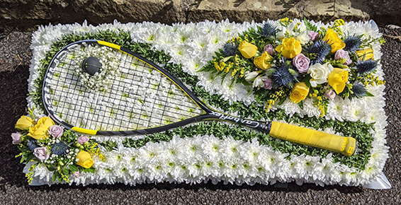 Oadby funeral flowers, Wigston funeral flowers, Squash racket tribute on flower bed.