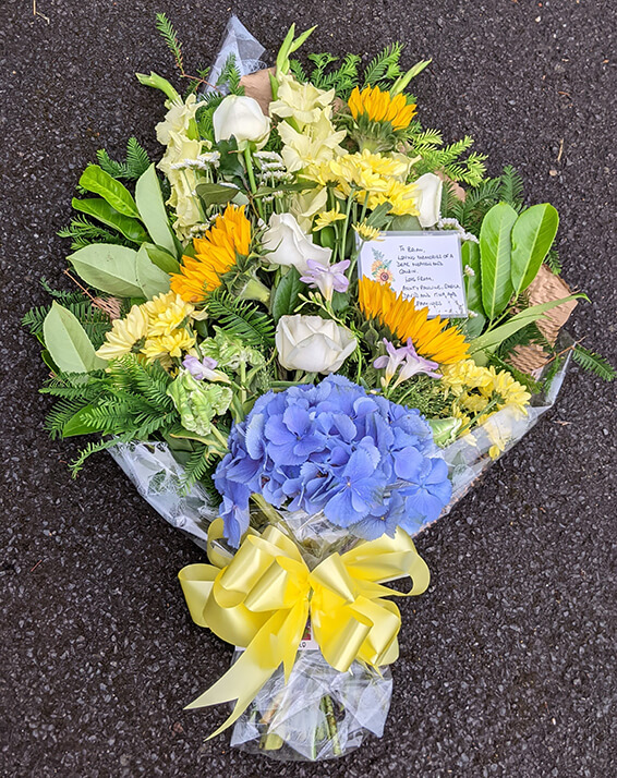 Oadby Funeral Flowers, Wigston Funeral Flowers, Market Harborough Funeral Flowers, Tied Sheaf Tribute with sunflowers & blue hydrangea