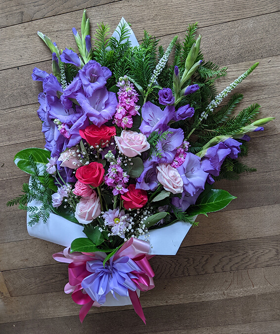 Oadby Funeral Flowers, Wigston Funeral Flowers, Tied Sheaf Tribute with purple & pink flowers
