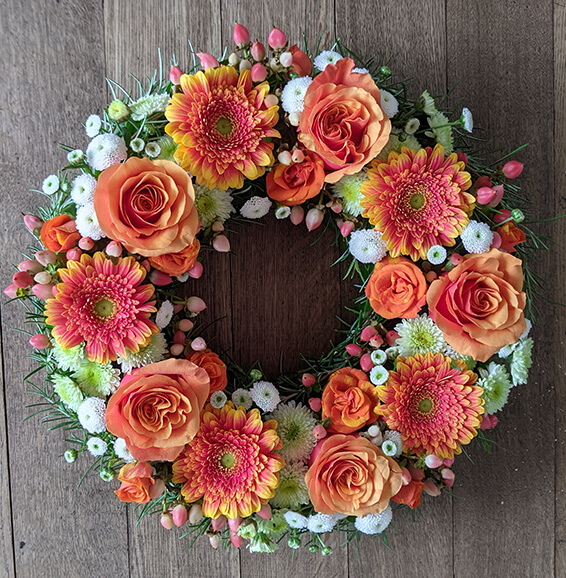 Oadby Funeral Flowers, Wigston Funeral Flowers, Market Harborough Funeral Flowers, Wreath ring Sympathy Tribute, Orange, white flowers