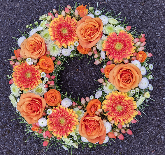 Oadby Funeral Flowers, Wigston Funeral Flowers, Market Harborough Funeral Flowers, Wreath ring Sympathy Tribute, orange and white flowers