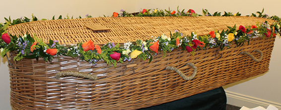 Oadby Funeral Flowers, Wigston Funeral flowers, Market Harborough Funeral Flowers, Leicester funeral flowers, Colourful garland for cassket, with vibrant flowers, roses, golden rod and various greenry