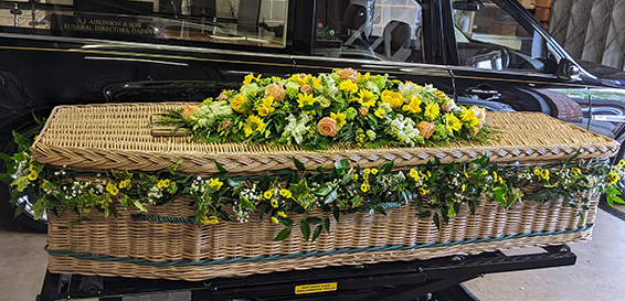 Oadby Funeral Flowers, Wigston Funeral flowers, Market Harborough Funeral Flowers, Leicester funeral flowers, Beautiful garland for casket, with greenery, white & lemon flowers with gypsophilla