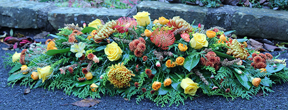 Oadby Funeral Flowers, Wigston Funeral Flowers, Leicester funeral flowers, Autumnal flowers & colours in a beautiful casket spray