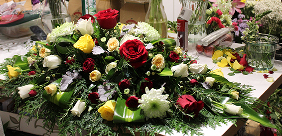 Oadby Funeral Flowers, Wigston Funeral Flowers, Leicester funeral flowers, Red and yellow and lime green casket spray