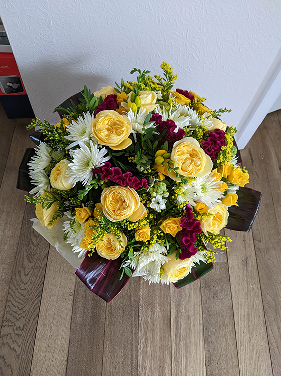 Oadby Funeral Flowers, Wigston Funeral Flowers, Market Harborough Funeral Flowers, Condolence Bouquet, Round Handtied bouquet with lemon, cream & maroon flowers surrounded with greenery