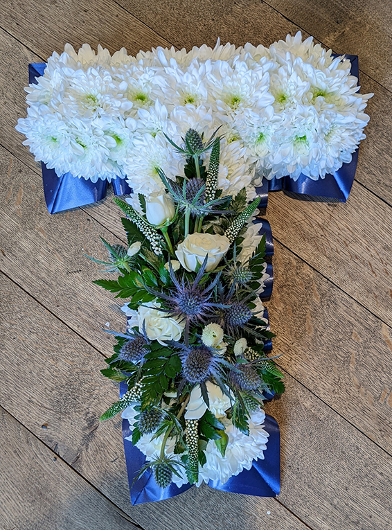 Oadby Funeral flowers, Wigston Funeral Flowers, Market Harborough Funeral Flowers, Leicester Funeral Flowers, Letter T, tradional style with large spray of blue & white flowers & ribbons