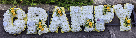 Oadby Funeral flowers, Wigston Funeral Flowers, Market Harborough Funeral Flowers, Leicester Funeral Flowers, GRAMPY tribute, traditional white based with yellow sprays and ribbons