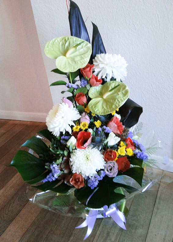 Oadby florist, Wigston florist, Lime anthurium, roses, anemones, tropical leaves, vertical handtied bouquet